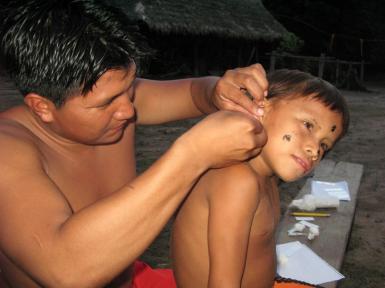 Mu'qui Rodríguez takes a blood sample in the remote community of Edwinña 